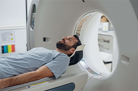 Young Man under CT-Scan Process